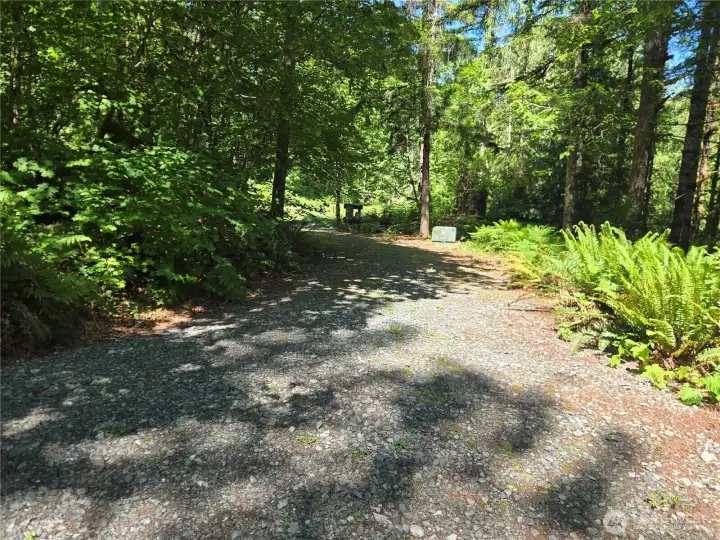 Right side of the circular drive. Drilled well and Electrical power are in! There are 2 locations with RV and 110 outlets.