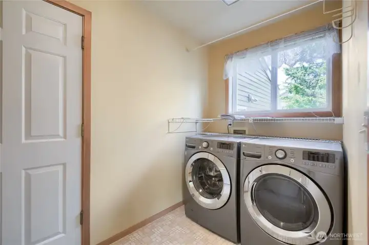 Main floor laundry room with access to 3 car fully finished garage.