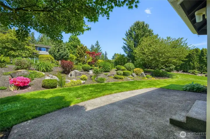 View of patio off house overlooking the 3/4 acre fully landscapped lot.