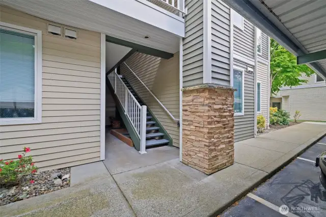 One flight of stairs to front door from covered carport reserved parking space