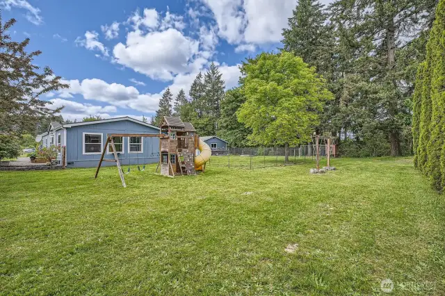 The big toy stays! There is also a functional chicken coop in the rear of the property. So much space for all of your activities!