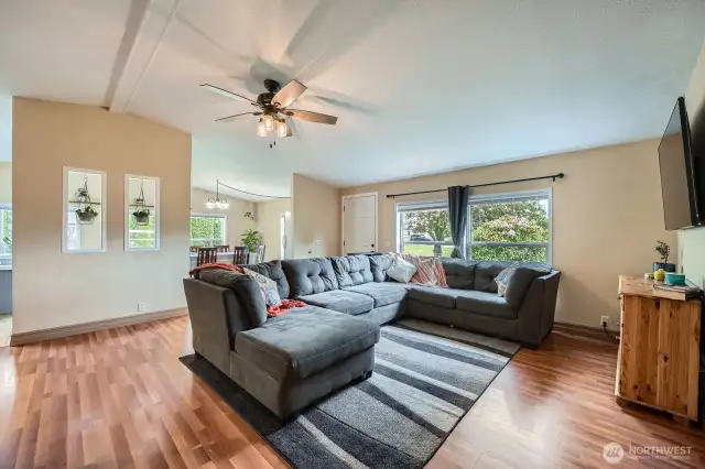 View of the living room looking toward the front door and dining room.