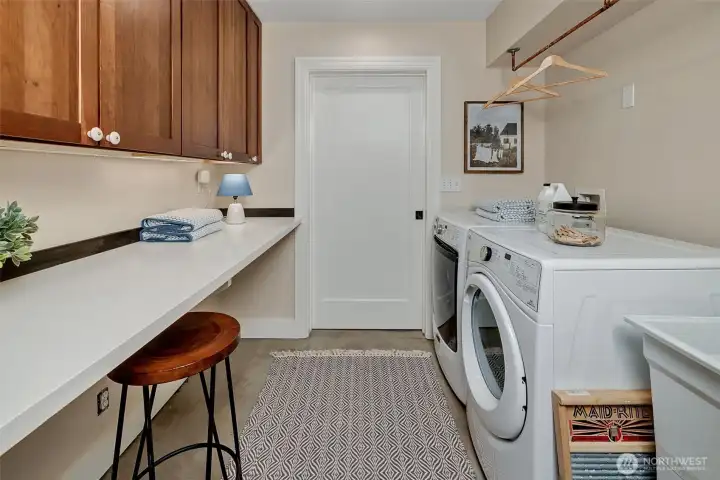 The laundry room has great storage and a folding/sewing area. Plus, a laundry sink handy for painting projects and dog baths. Maybe even cat baths if you enjoy washing cats.