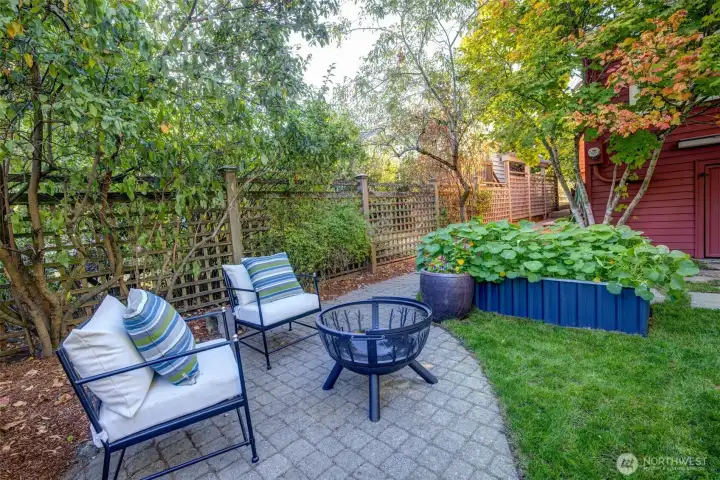 A patio provides a nice place to rest and admire the garden.