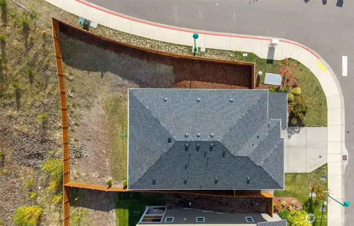 Aerial image of the home and fenced yard.