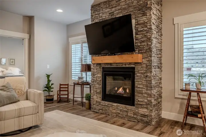 Propane fireplace with stone surround provide a focal point in the space. Plantation shutters really elevate the home.