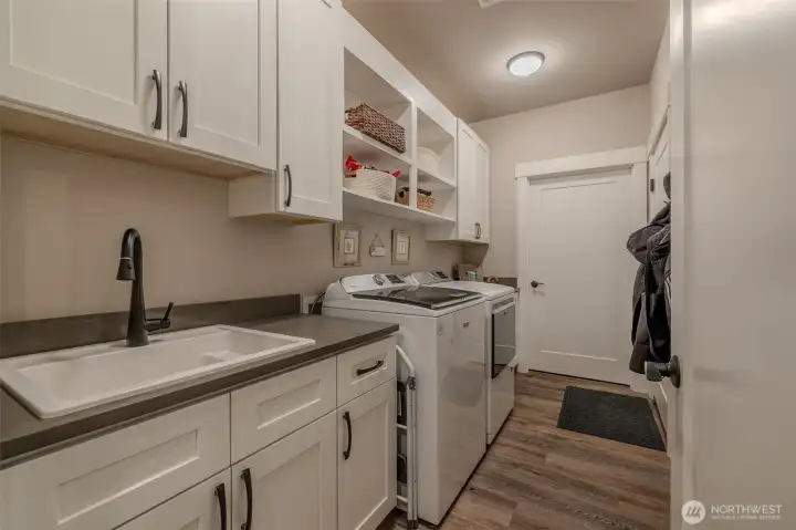 Laundry room with utility sink and lots of storage