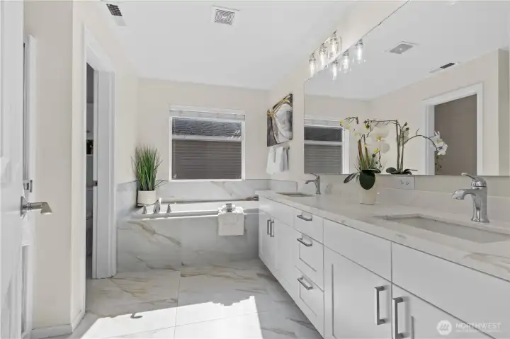 Updated 5-piece primary bathroom with private water closet.