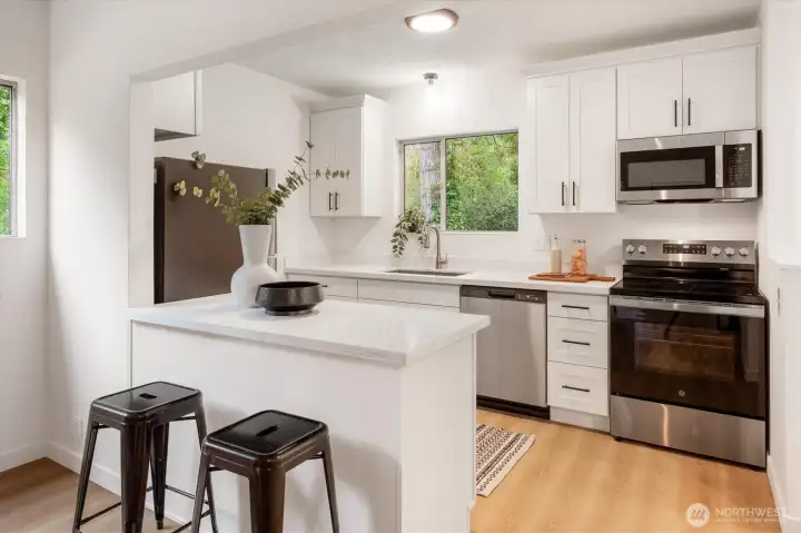 East Cottage - 22511 1/2: The new kitchen stands out with new stainless steel appliances.