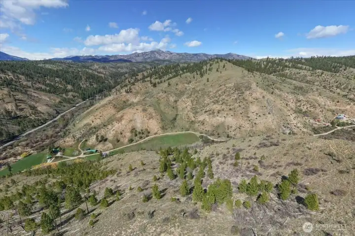 Aerial picture of hillside with usable property below.