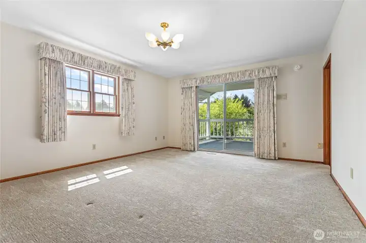 Upstairs bedroom with private covered balcony.