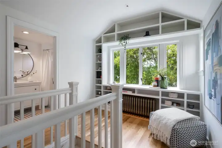 Landing at the top the stairs with nooks for display