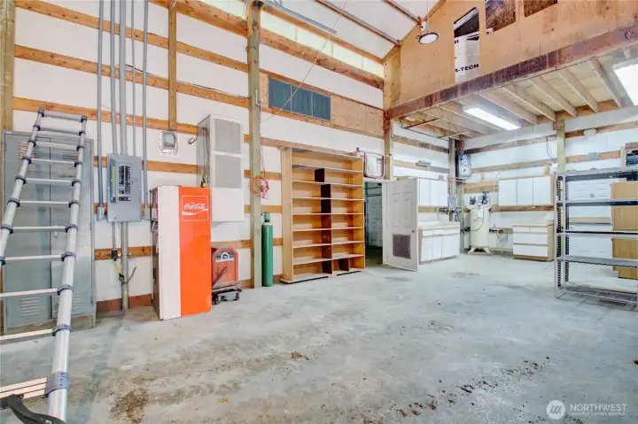 High ceilings, loft and commercial air compressor. High ceilings, loft and commercial air compressor.