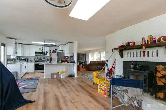 Cozy family room with a wood stove insert fireplace looking through the kitchen