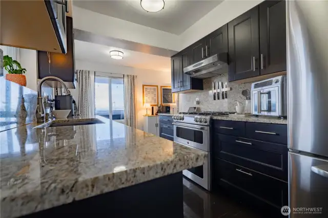 Sleek stainless appliances, a gas range, and double ovens make this kitchen both beautiful and functional.