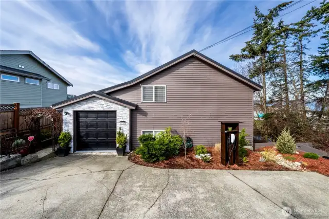 Gorgeous views, a private trail, a hot tub, and even a Tesla charger—this home has it all!