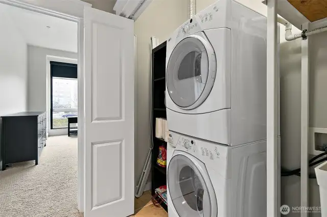 The closet is equipped with a full-size stackable washer and dryer, offering ample space for laundry and additionally a convenient stand-alone sink providing functionality for handwashing or cleaning up after projects.   Washer and dryer remain with the sale of the condo.