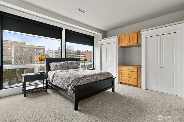 Primary bedroom designed for both comfort and style. Large windows have blackout shades that allow you to control natural light and create the perfect ambiance for rest and relaxation.