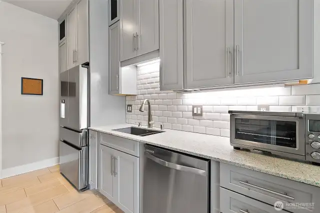 The cabinets extend gracefully to the ceiling and they offer generous amounts of storage.