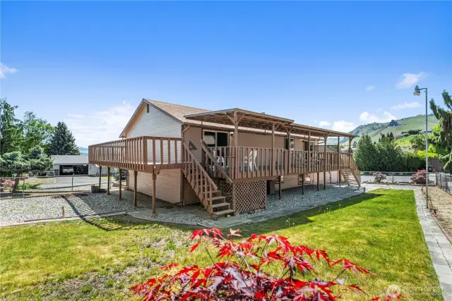 Cozy fenced back yard with wrap-around deck.