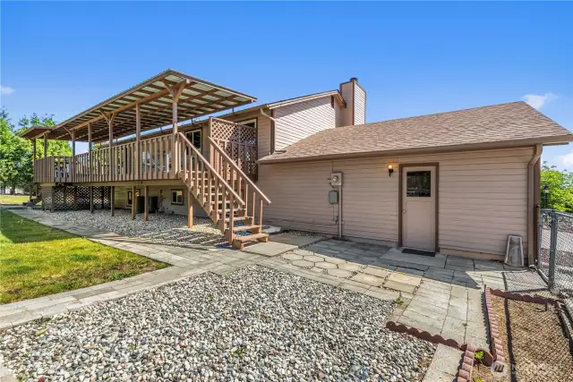Side yard with garden space and room for entertaining.