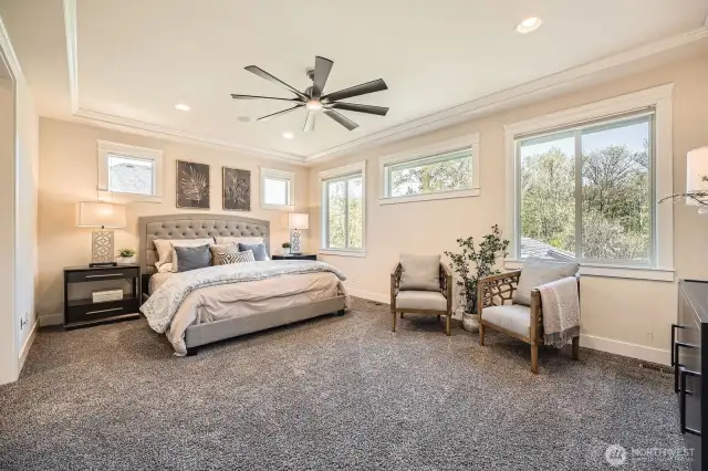 Spacious Primary Suite with serene views overlooking the backyard.