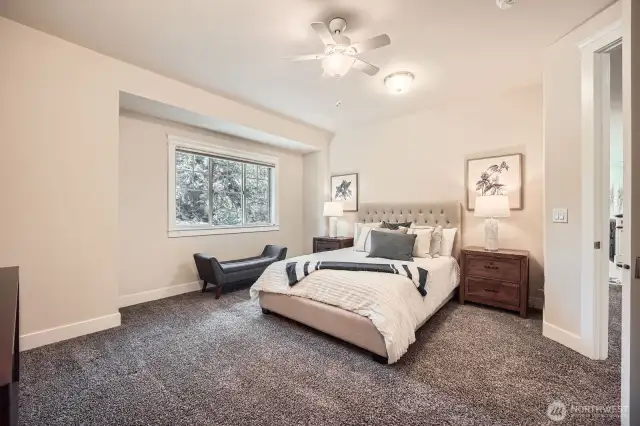 Large secondary bedroom (Bedroom 4) or guest room comfortably fits a king-sized bed, shown here with a queen. Features a charming bump-out niche at the window, adding character and extra space.