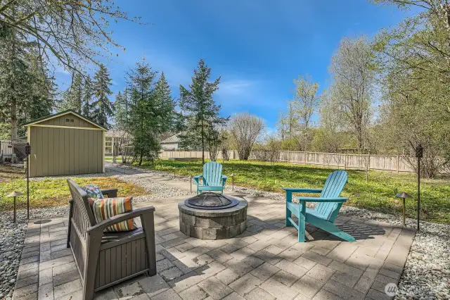 Ground-level view of the backyard firepit and rear portion of the fully fenced lot. The expansive “Back 40” feels like a private retreat, yet remains fully secured within the property’s fencing and integrated security system—ideal for kids camping, peaceful evenings and added peace of mind.