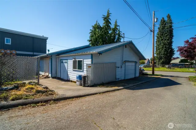 Backside from alley, showing extended shop area and the work/ park pad- dont miss the gate that pulls across!