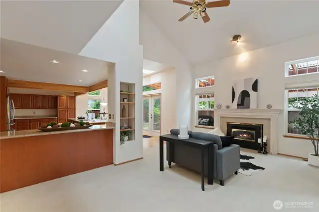 The kitchen seamlessly integrates with the family room, featuring a gas fireplace and vaulted ceilings.