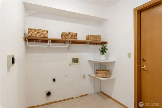 Laundry room off of garage with room for storage.