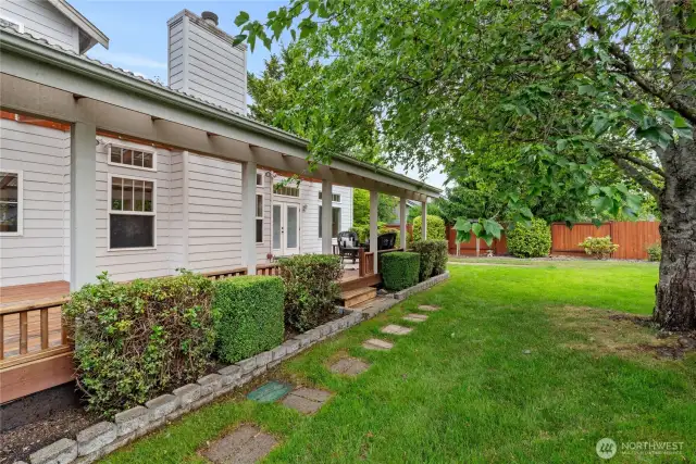 The backyard is well-maintained and includes two garden sheds, which are located on the side of the house and not visible in the picture.