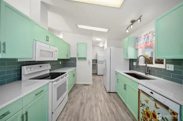 Updated kitchen with Corian countertops and newer appliances.