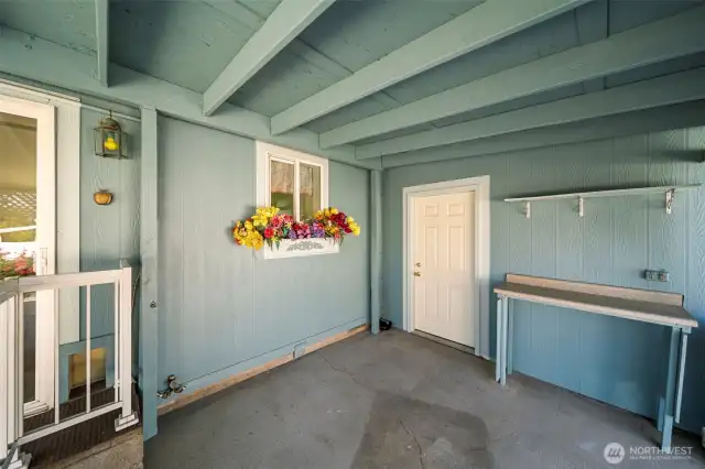 Covered patio with exterior man-door to garage.