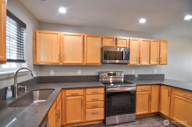 The Warmth of the cabinets and updated counters and flooring give this home a cozy but updated feel.