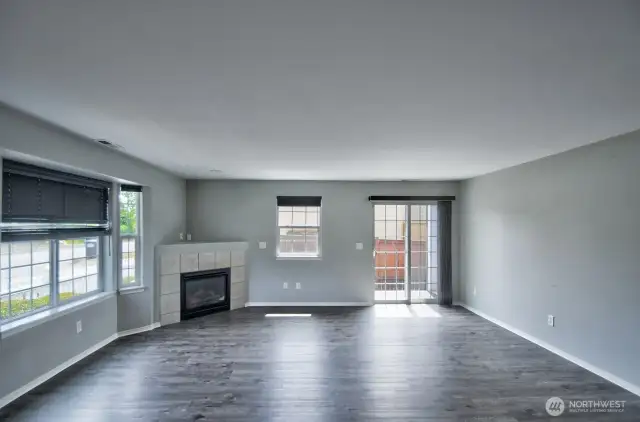 Light and Bright Great Room, with cozy corner fireplace and slider to the side yard/patio.