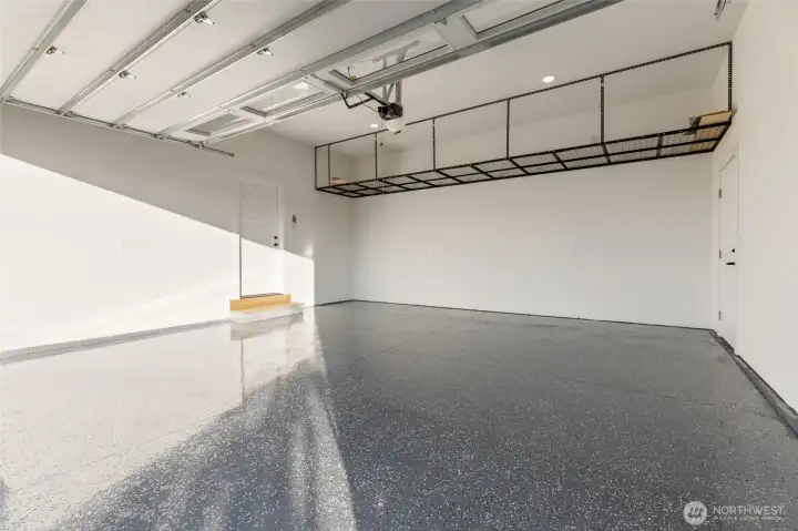 Attached Garage with an 18' Wide Door, Epoxy Floor, Upper Storage & EV Charging ...