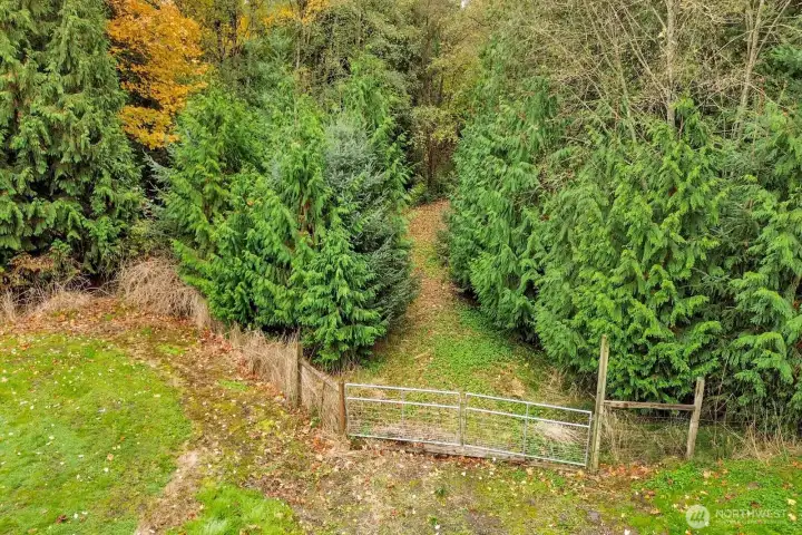 Gate that leads to the bridge and the back 1/2 of the property.