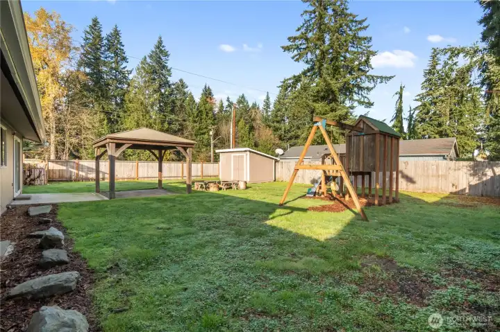 Excellent play structure, quaint firepit and generous shed in this private back yard.