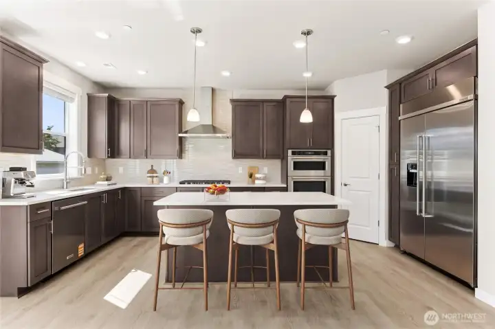 Home includes gas cooktop & 30" built in refrigerator - home for sale includes white cabinetry, virtually staged.