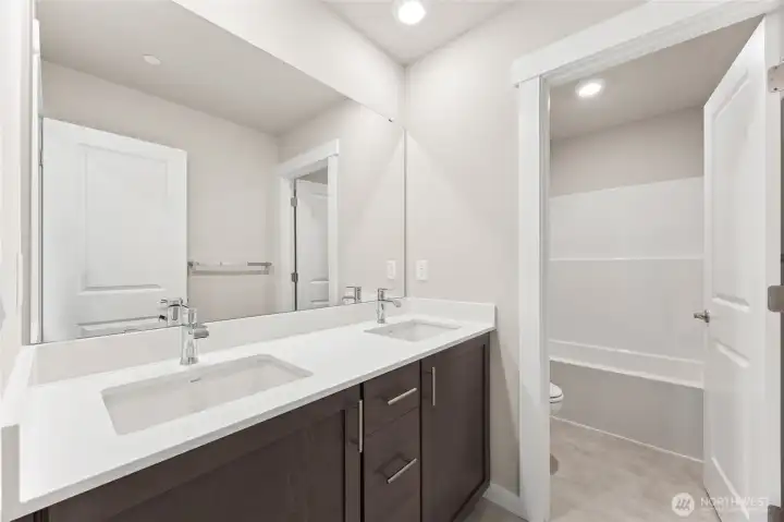 Main floor bath will include white cabinetry.