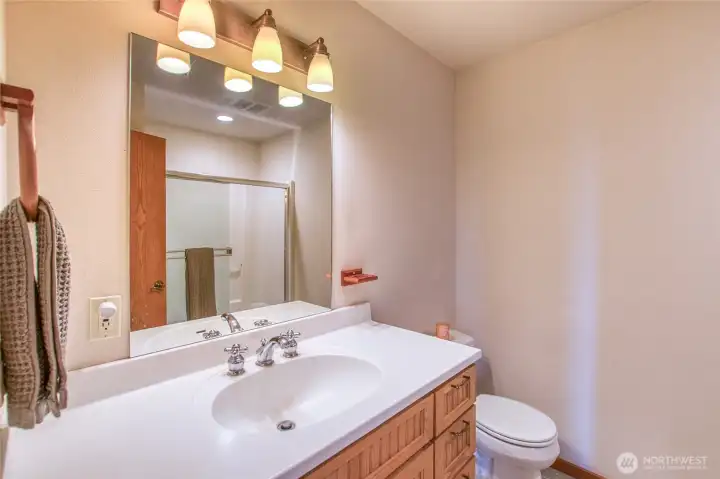 Downstairs full bath with new towel heater.  Linen closet just outside the bath.