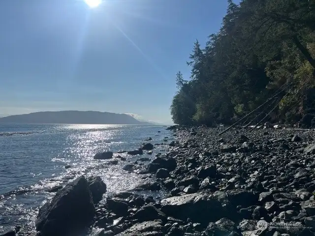 Massive private beach access below the house.  A well maintained walking trail heads to this rocky shoreline