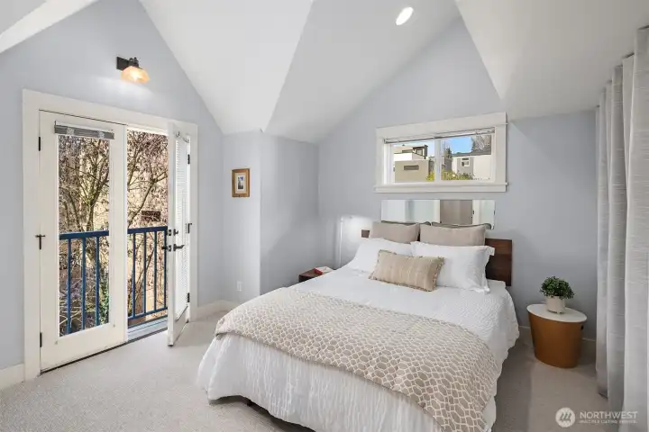 Upstairs, your primary suite awaits you with a private balcony.