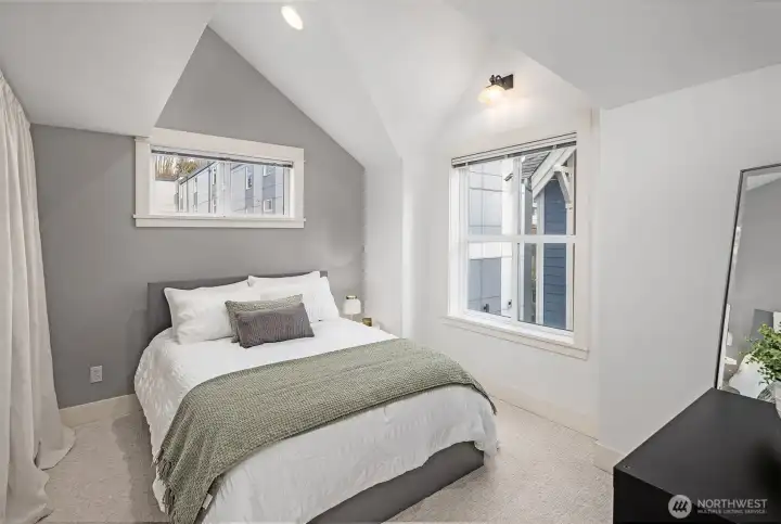 Second upstairs bedroom also enjoys a lofty cathedral ceiling.