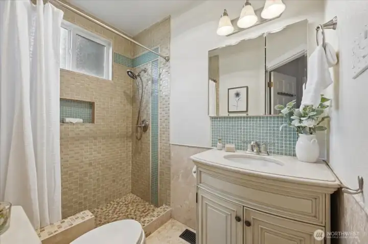 Tiled three-quarter bathroom.