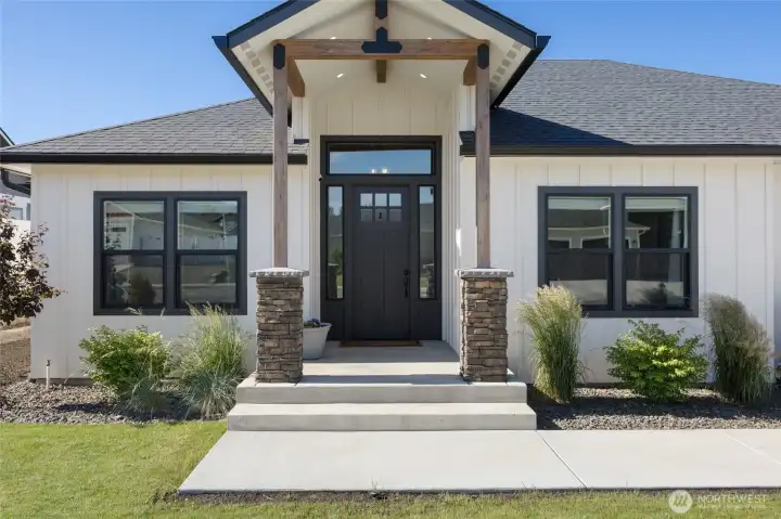 Perfect front porch welcomes you with large windows and oversized door Perfect front porch welcomes you with large windows and oversized door