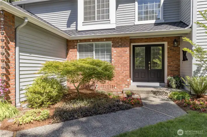 Double door entry with charming planting area