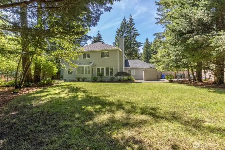 Fully-fenced yard offers an expansive level lawn with plenty of space to play or relax.