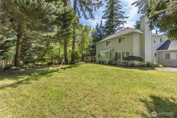 Enjoy the perfect blend of sun-drenched lawn and cool, shaded areas provided by the mature trees.